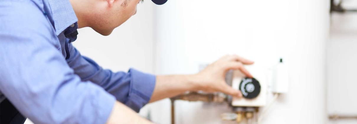 Man adjusting a thermostat