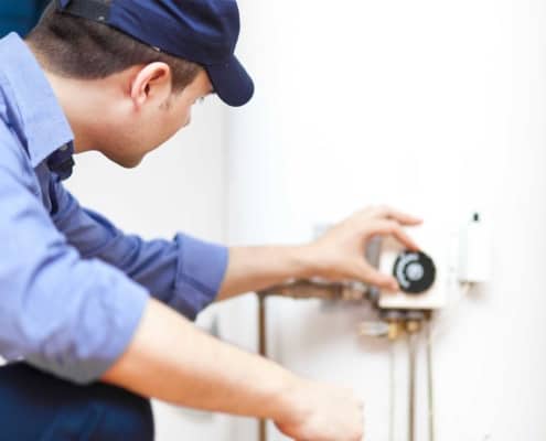 Man adjusting a thermostat