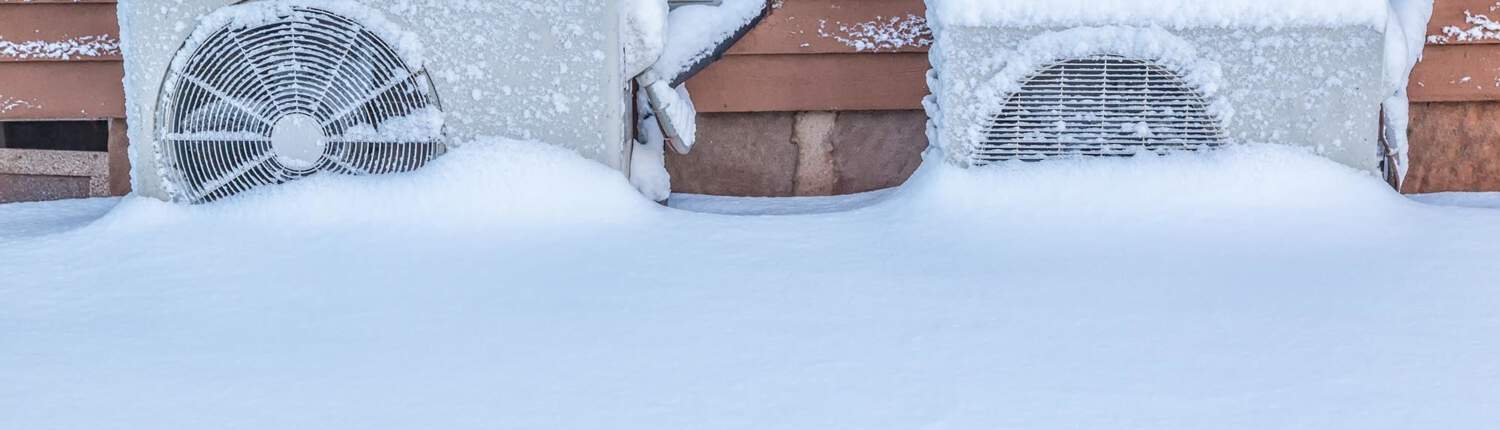 Outdoor HVAC systems covered in snow