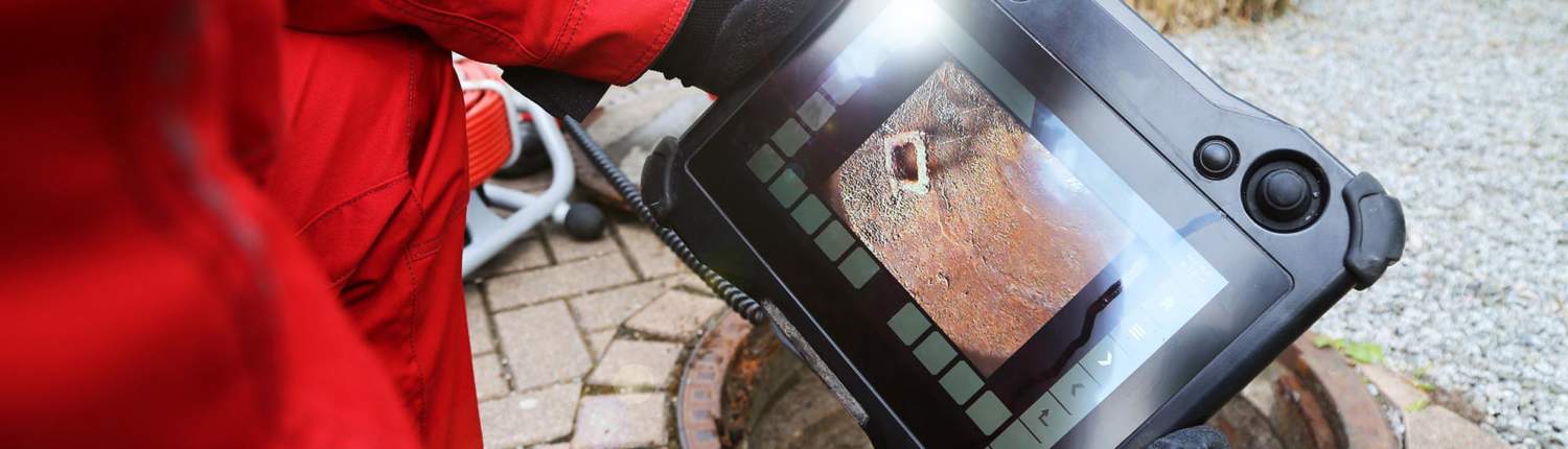 Image of workers inspecting a sewer line.