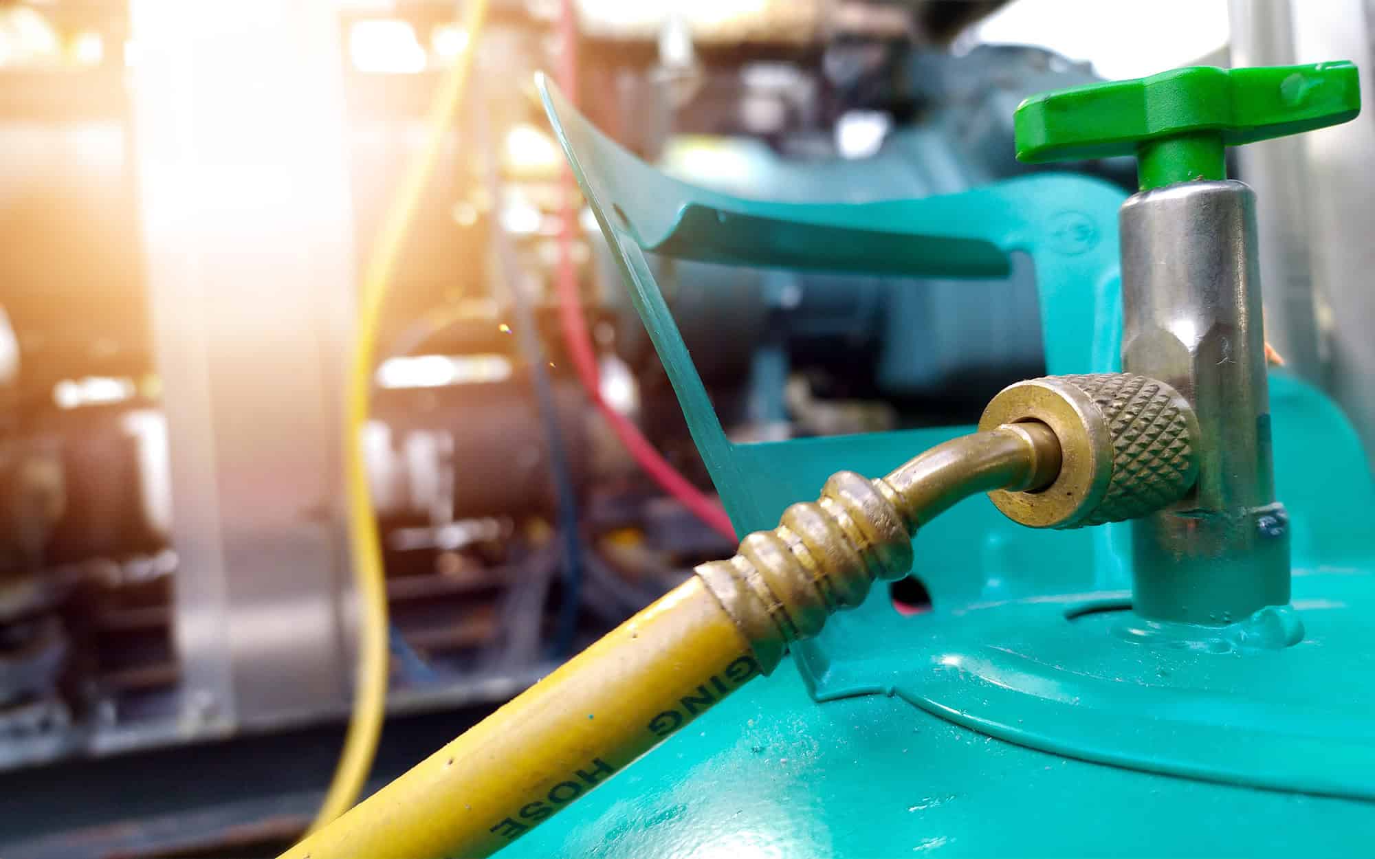 Close up view of refrigerant hooked up to HVAC unit