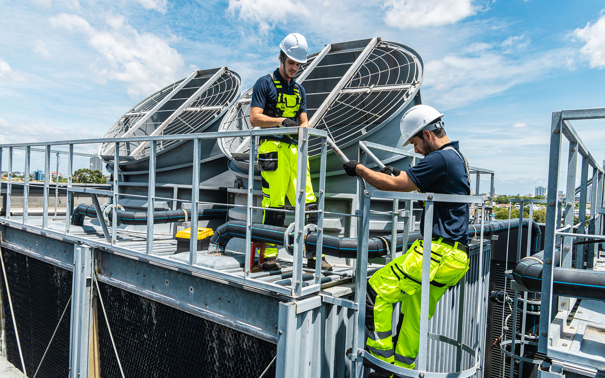 Professional worker servicing HVAC building cooling tower, Industry air conditioner service