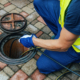 service worker cleaning blocked sewer line with hydro jetting