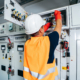 engineer testing and screwing equipment in fuse box