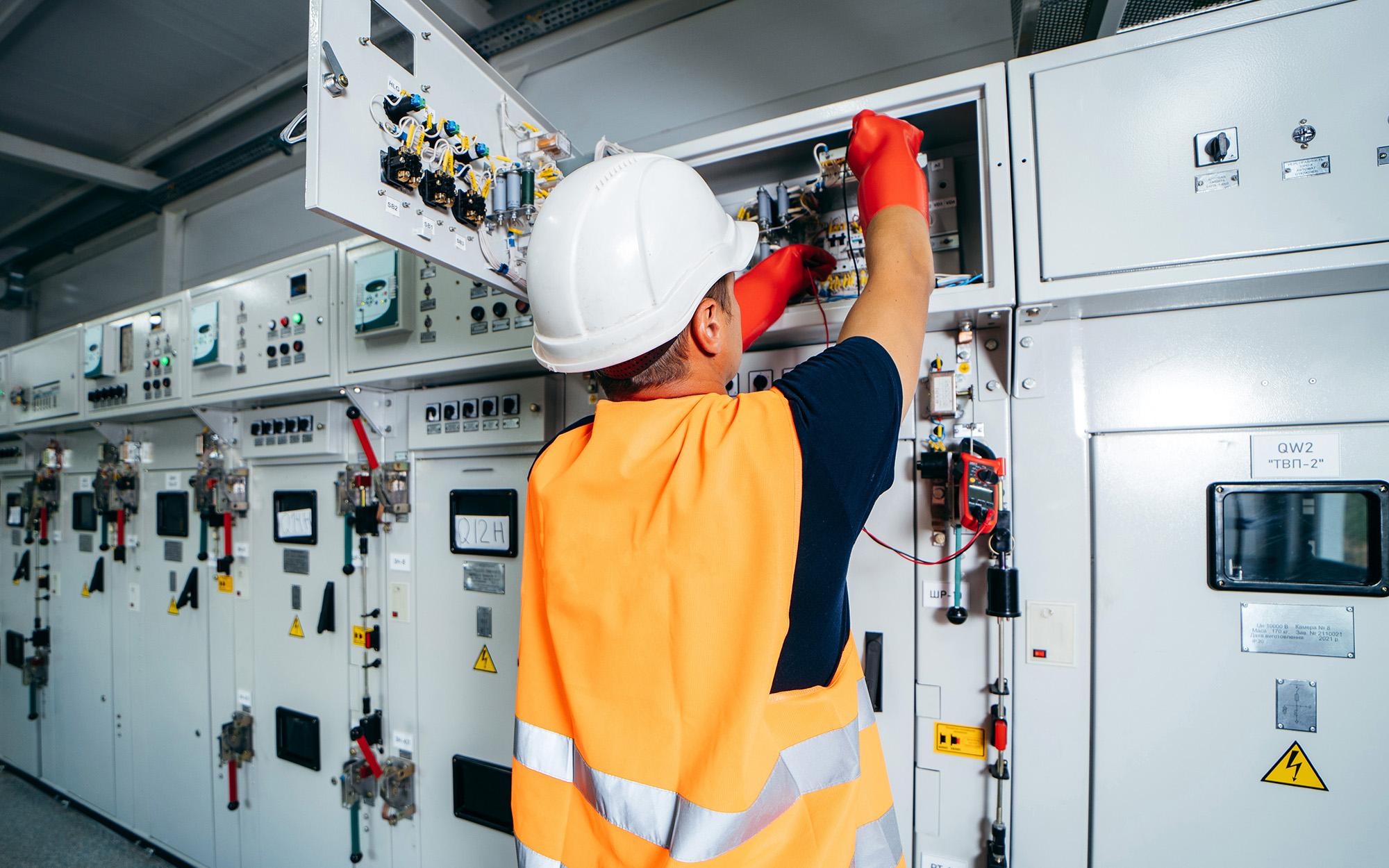 engineer testing and screwing equipment in fuse box